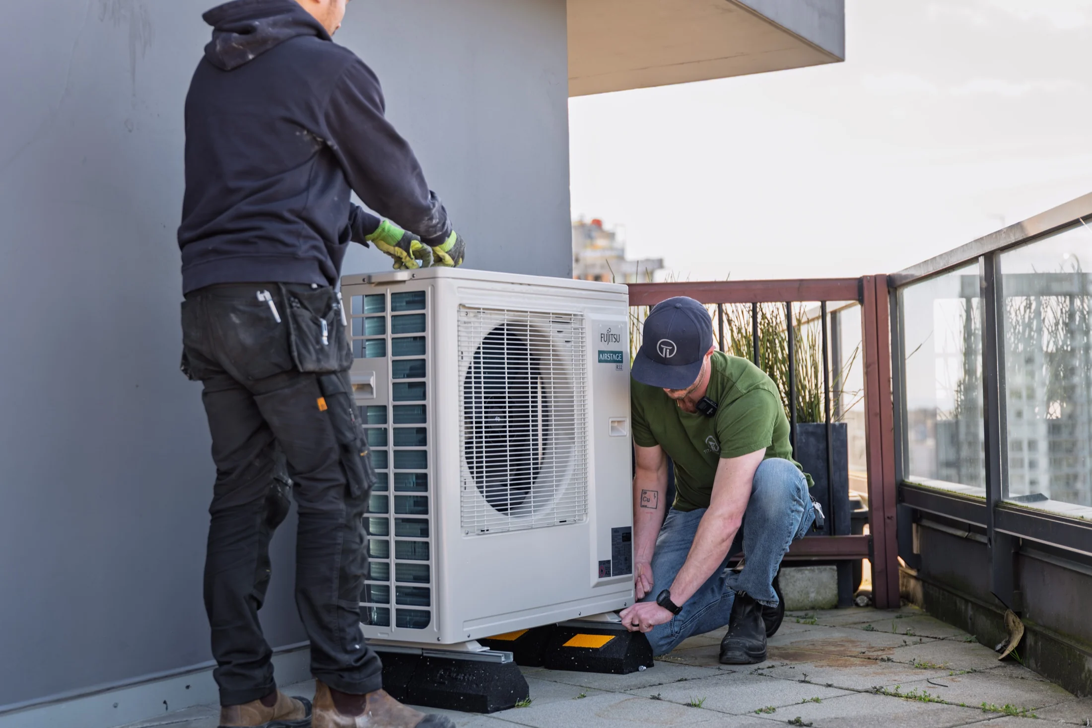 Titanium HVAC technicians installing a heat pump